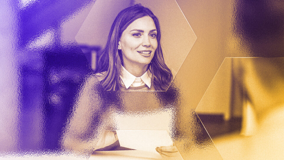 Excited young woman with paper bills in hands finally paying down her mortgage debt at home